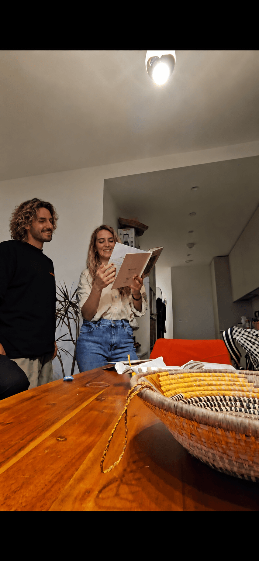 Our friend opening her storybook, with Denis beside her.