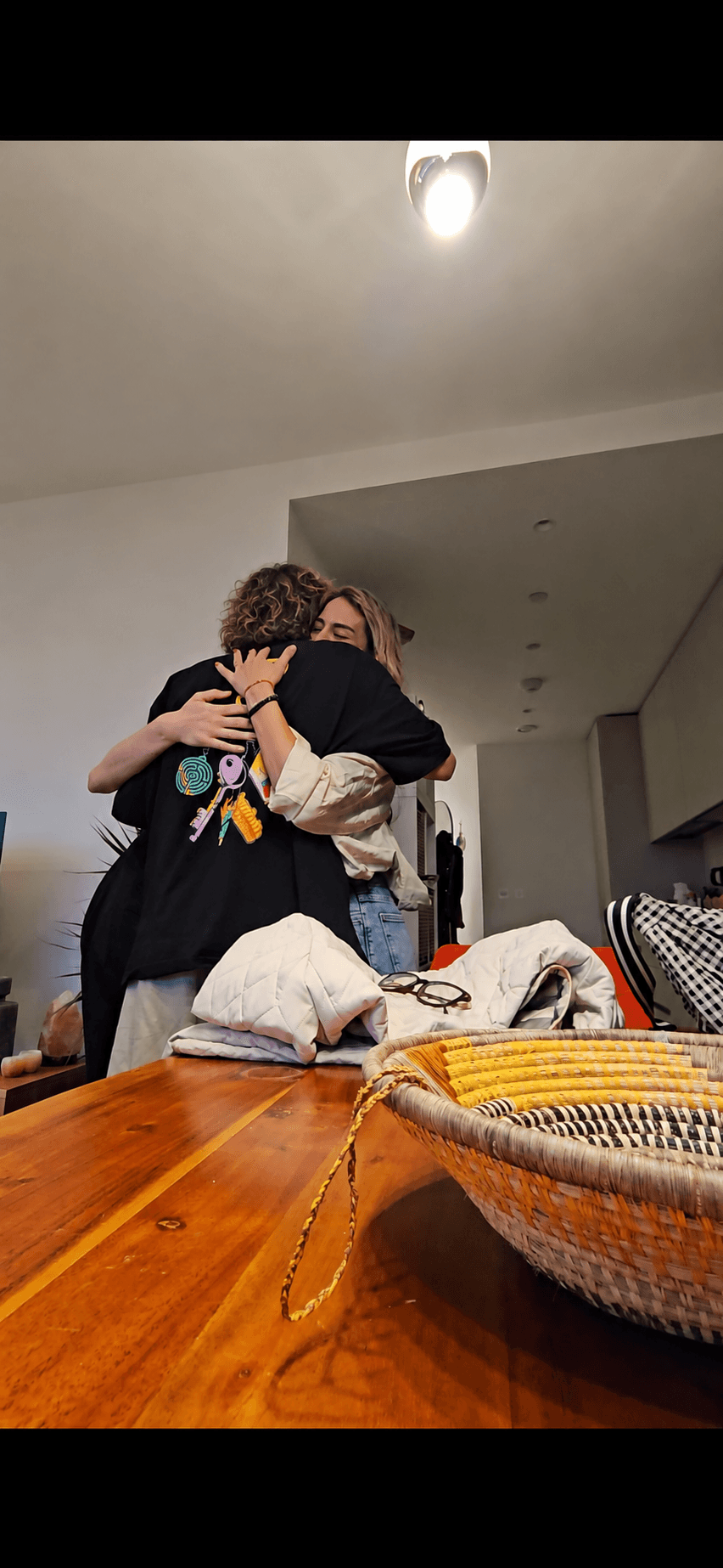 A hug after giving our friend her storybook. Denis faces away from the camera.