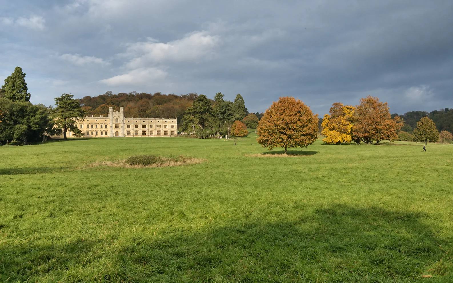 Ashton Court Mansion beyond open grassland and autumn trees