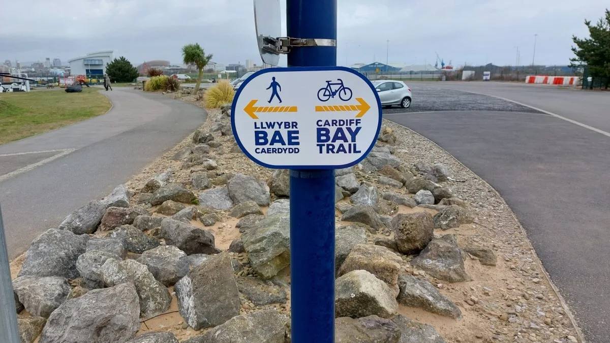 Blue Cardiff Bay Trail waymarker beside the Barrage path