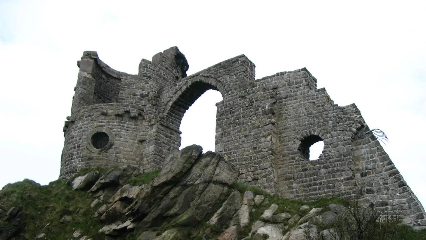 The ruined stone castle folly standing on the rocks at Mow Cop