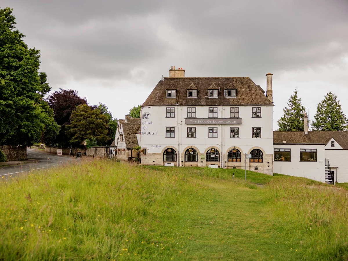 The Bear of Rodborough hotel overlooking the grass of Rodborough Common
