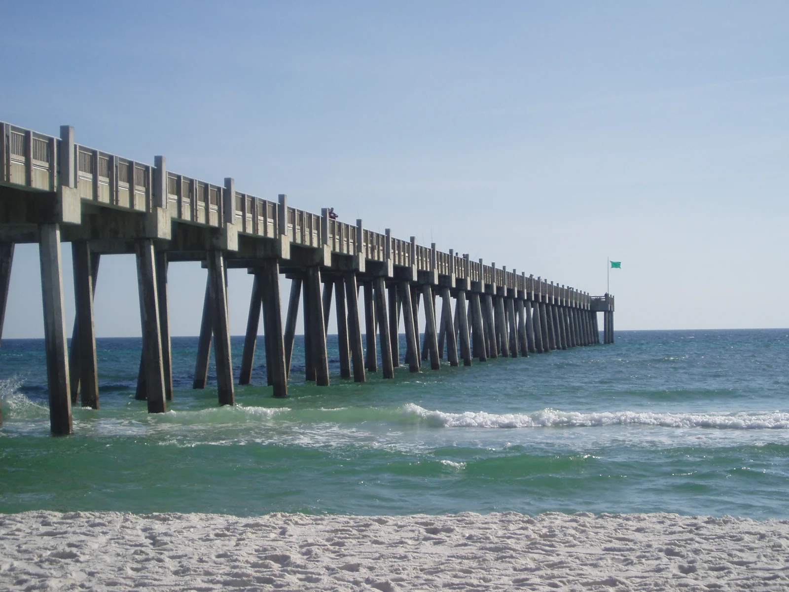 Gulf Pier extends over the bright water and sand at Pensacola Beach, shown as regional shoreline context.