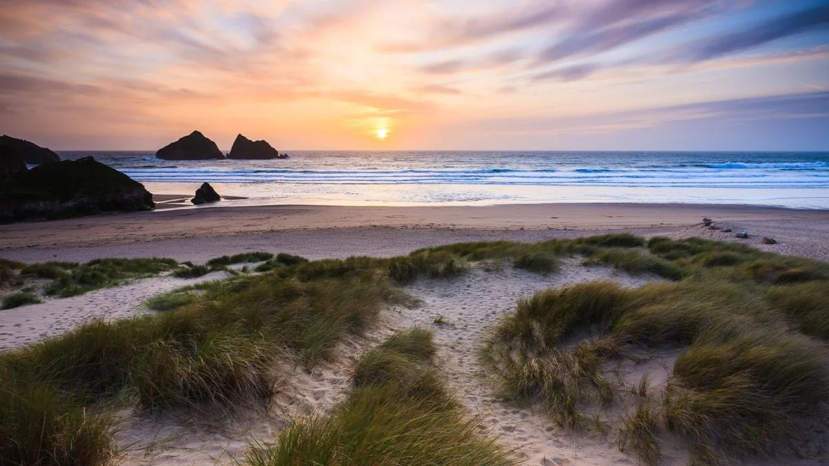 Holywell Bay beach at sunset.