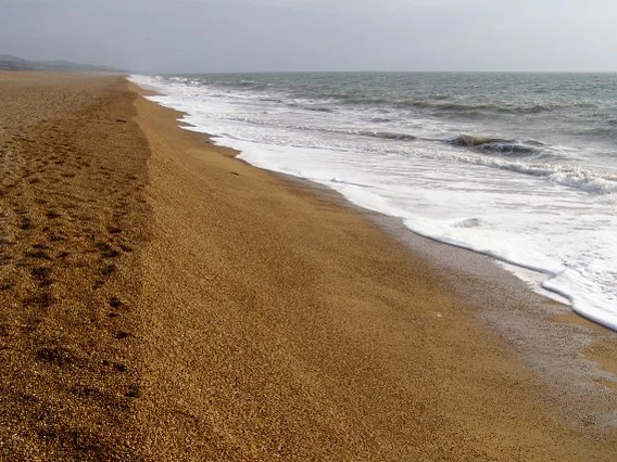 Shingle shoreline and breaking waves at Cogden Beach