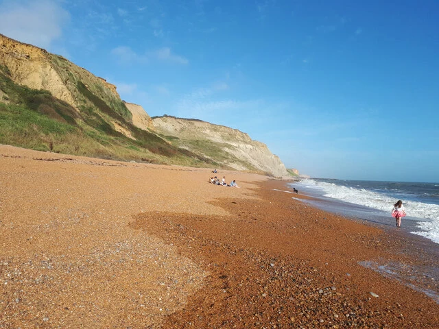 Eype Beach with golden shingle below the cliffs