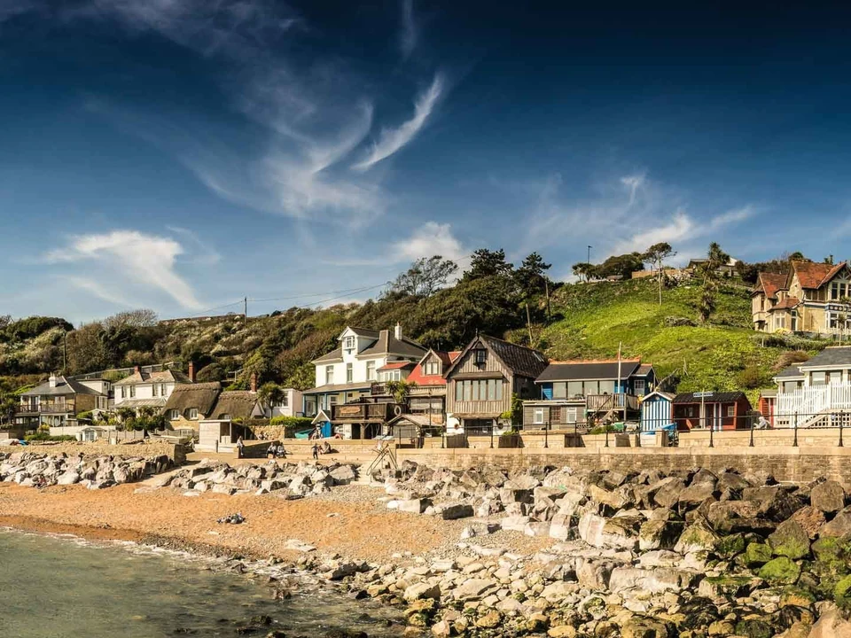 Cottages and the rocky shoreline at Steephill Cove