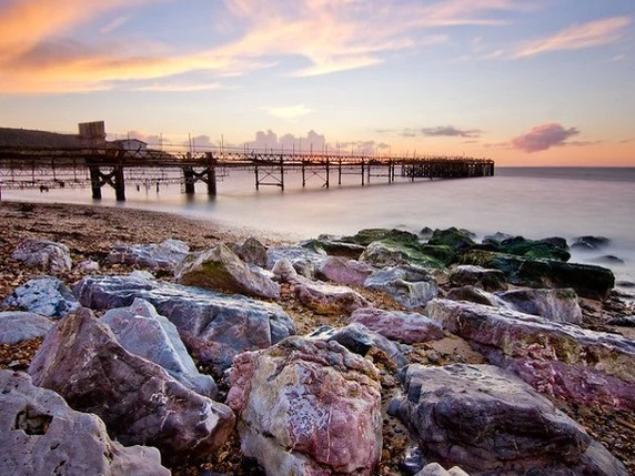 Totland Bay shoreline and pier at sunset