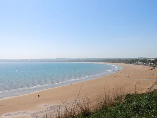 Wide sandy curve of Filey Beach from the cliff top