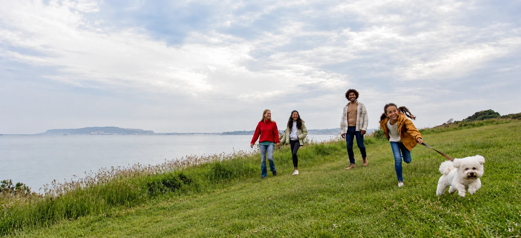 A family walking their dog above Bowleaze Cove in autumn