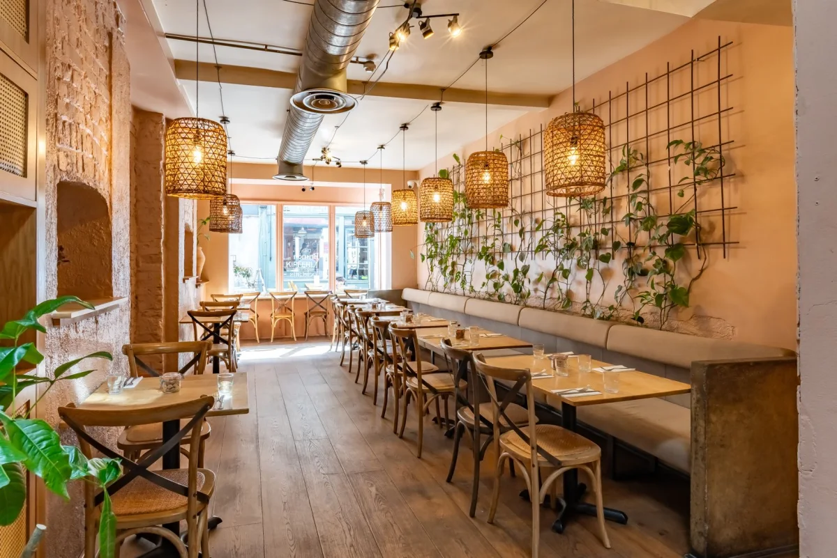 The warm plant-filled dining room at Brother Marcus Angel in Camden Passage