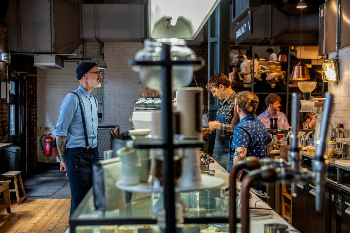 Baristas working behind the counter at Ozone Coffee Shoreditch on Leonard Street