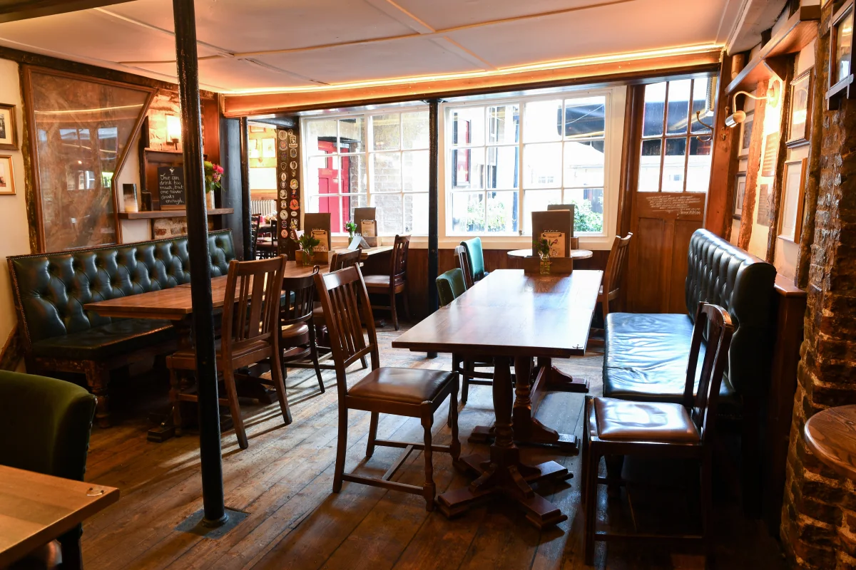 Warm wooden dining room inside The Eagle in Cambridge