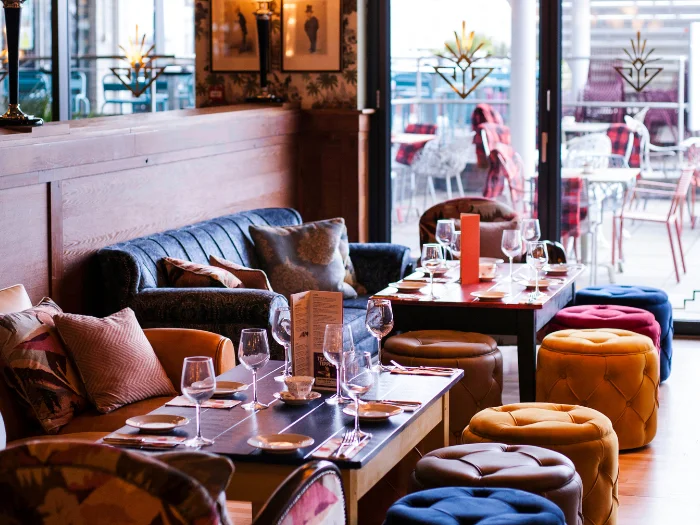 Interior seating and tables at Cosy Club Cardiff Bay