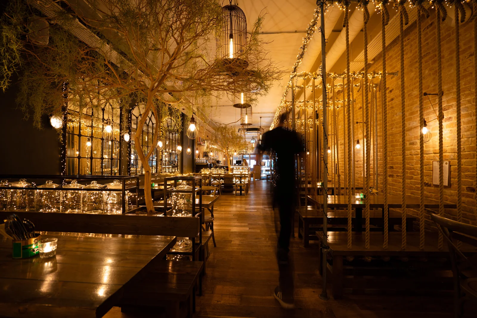 Warm lighting and tables inside Mowgli Cardiff
