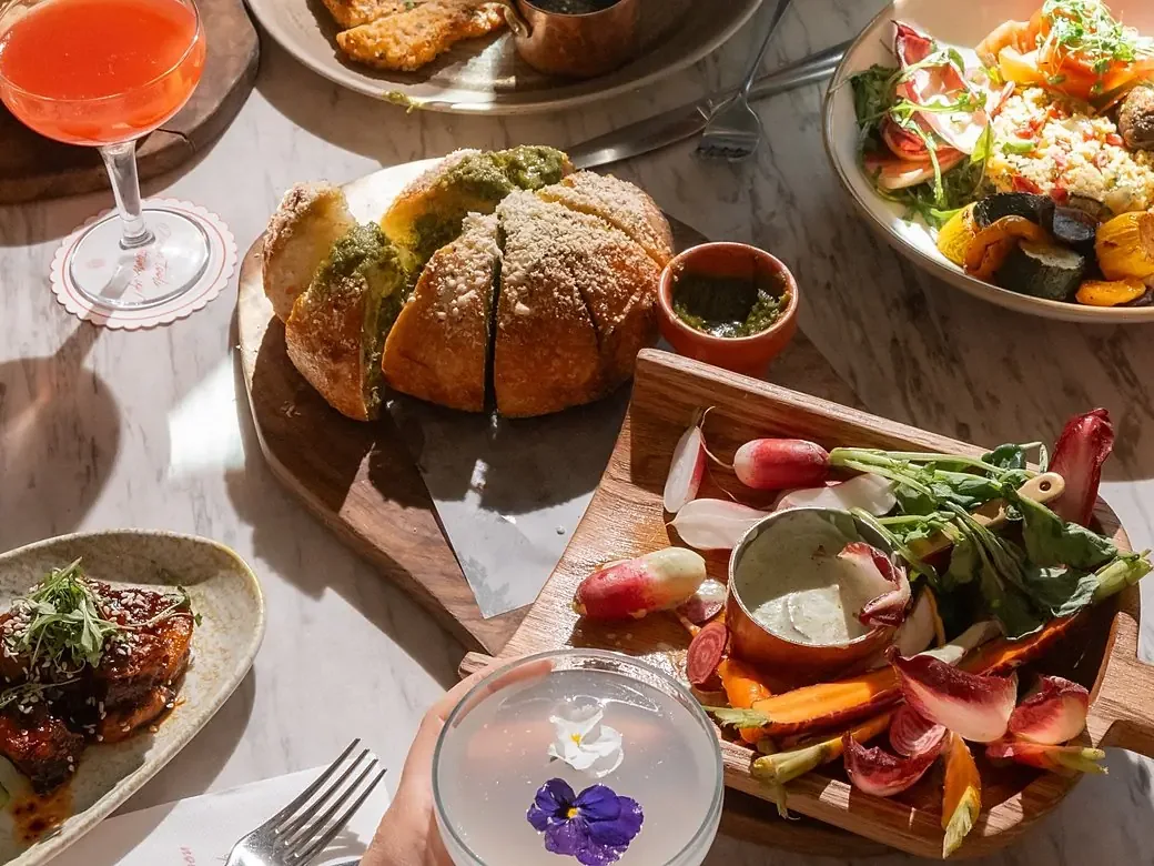 Sharing dishes and bread from The Botanist official food photography