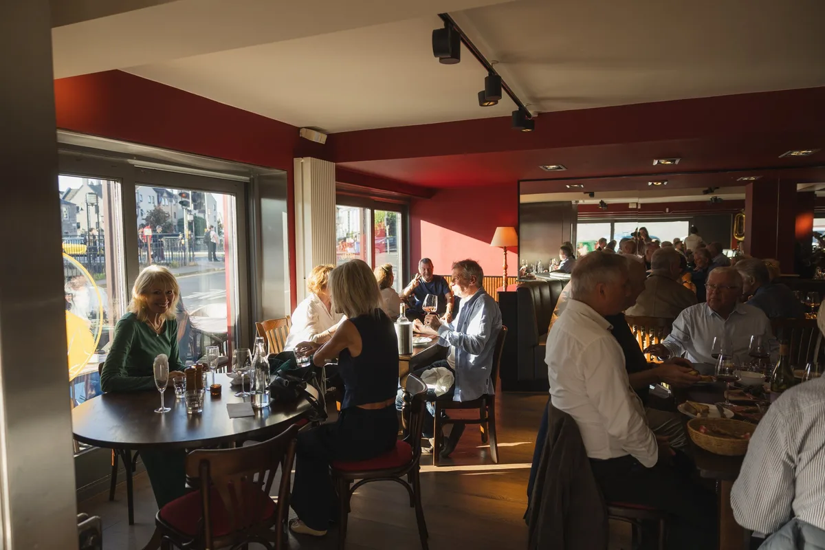 Guests dining beside the Shore-facing windows inside Chez Bernard.