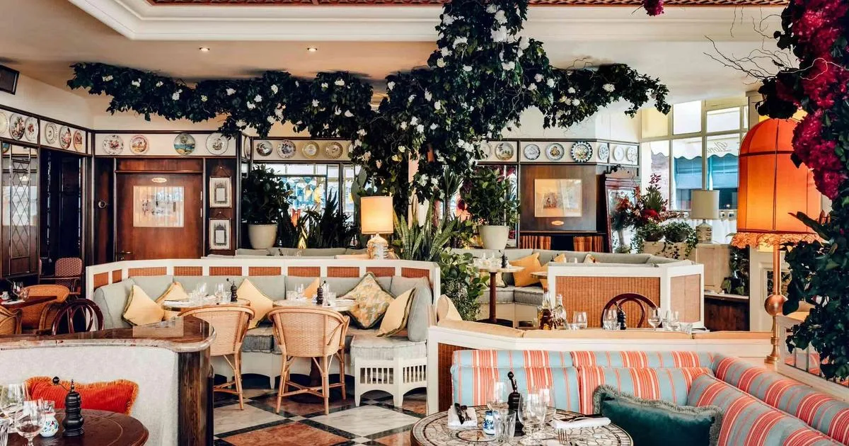 Gloria Shoreditch dining room with striped seating, plants and set tables