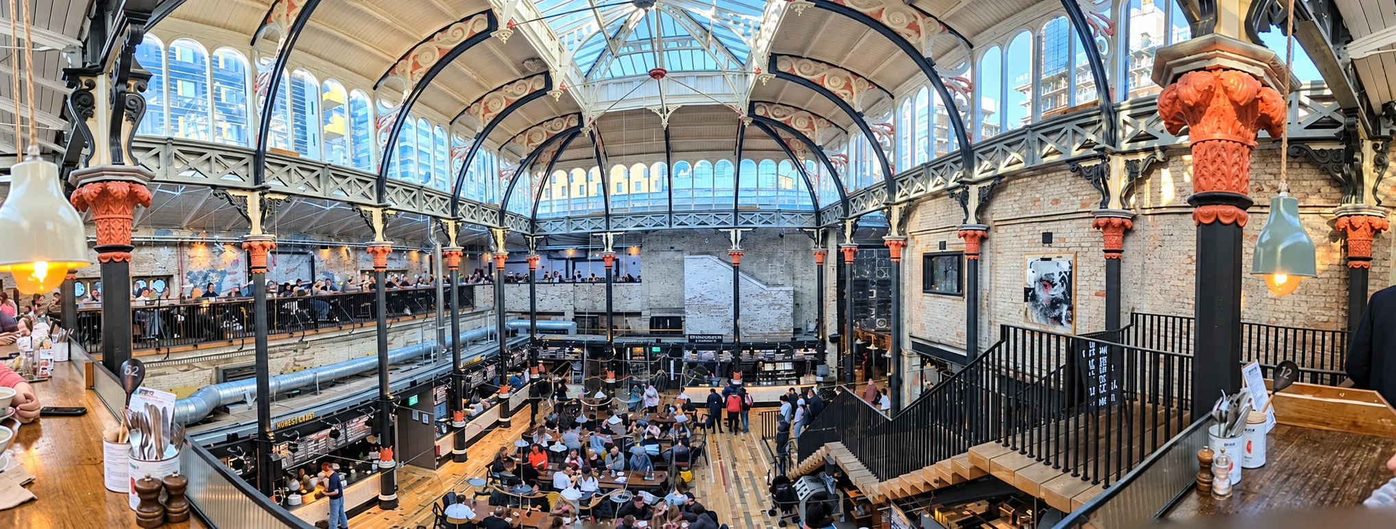 Diners in the glass-roofed Mackie Mayor food hall